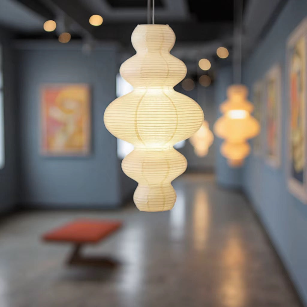 Sculptural cream paper pendant light with a tiered organic shape in a modern hallway
