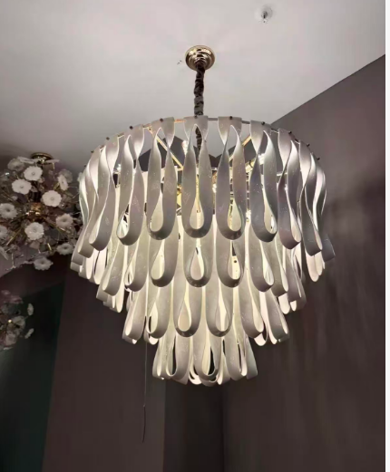 Silver teardrop cascade chandelier with layered hanging pendants and sculptural design