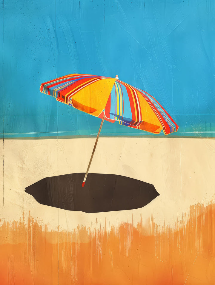 Wadi Home framed wall art featuring a vibrant striped beach umbrella on a sandy shore, displayed in a coastal living room