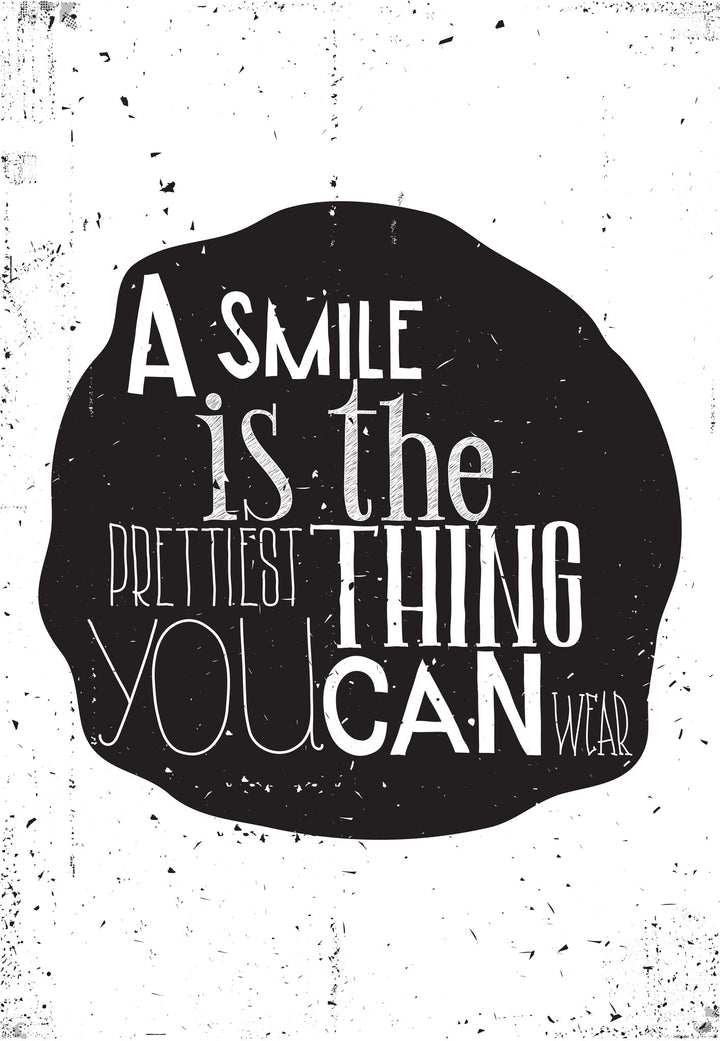 Wadi Home typography wall art print with a smile quote on a textured black shape in a modern living room interior.