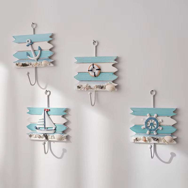 Set of nautical key holder hooks with anchor and ship designs on wall mount