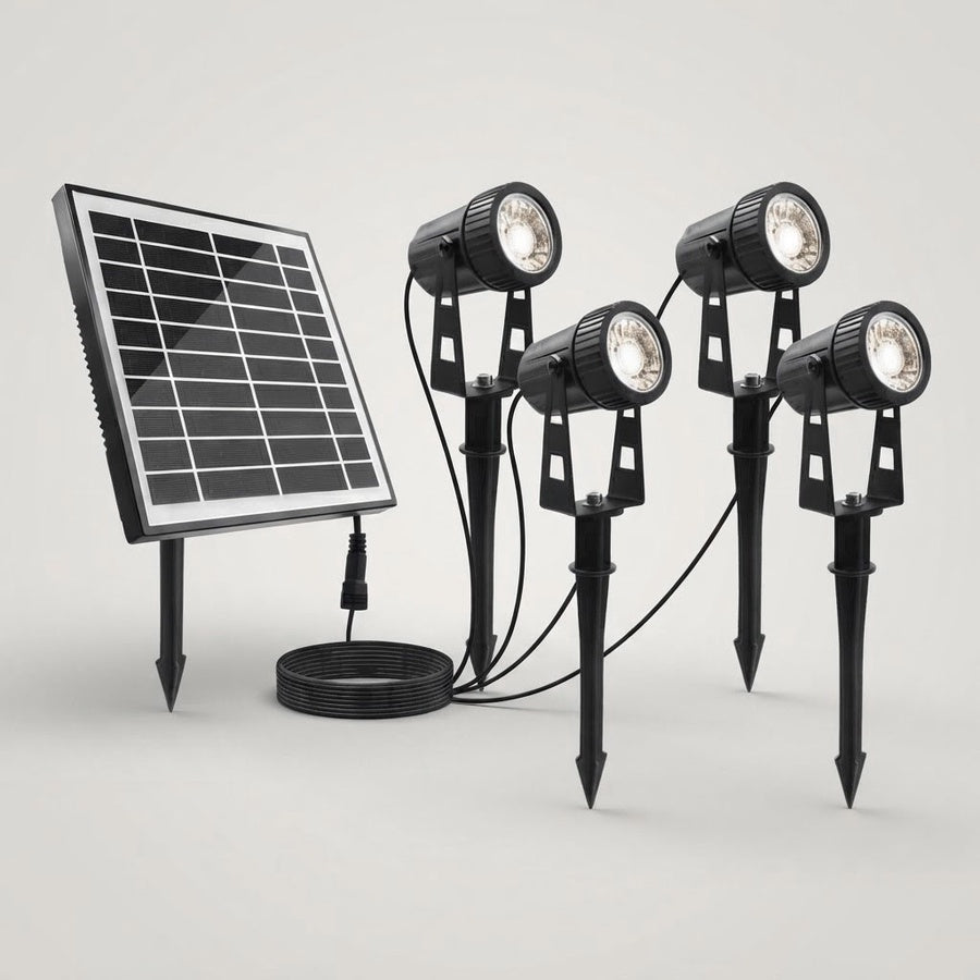 Four black stake-mounted solar garden spotlights connected to a separate solar panel