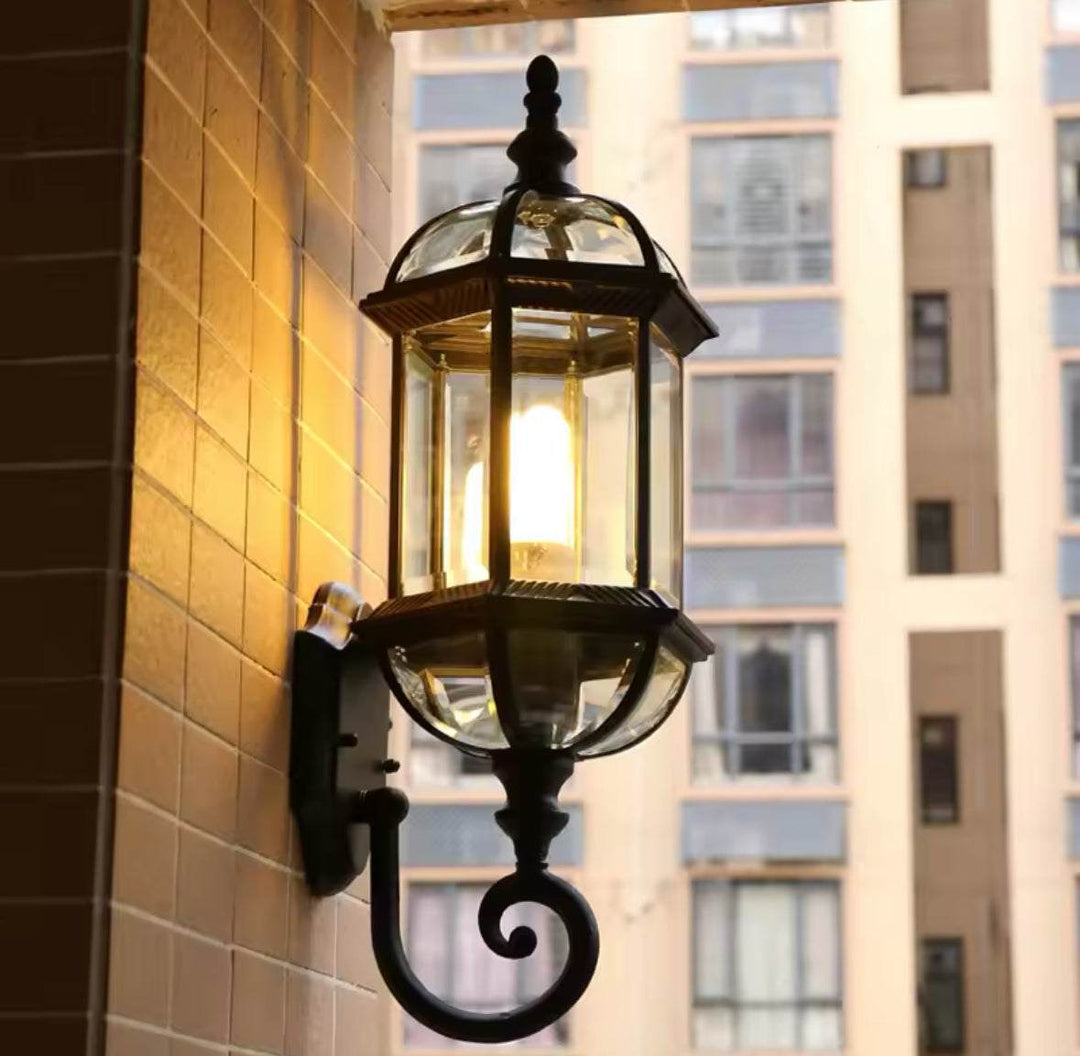 Outdoor Wall LanternOutdoor Wall Lantern with Glass Panels and Vintage DesignThis outdoor wall lantern features a vintage-inspired design with clear glass panels and a durable black metal frame. 
 Perfect for gardens, patios, or entryways, itOutdoor LightsWadi Home