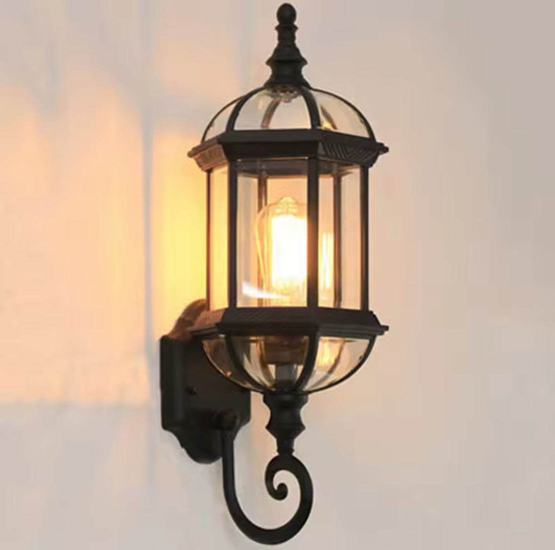 Outdoor Wall LanternOutdoor Wall Lantern with Glass Panels and Vintage DesignThis outdoor wall lantern features a vintage-inspired design with clear glass panels and a durable black metal frame. 
 Perfect for gardens, patios, or entryways, itOutdoor LightsWadi Home