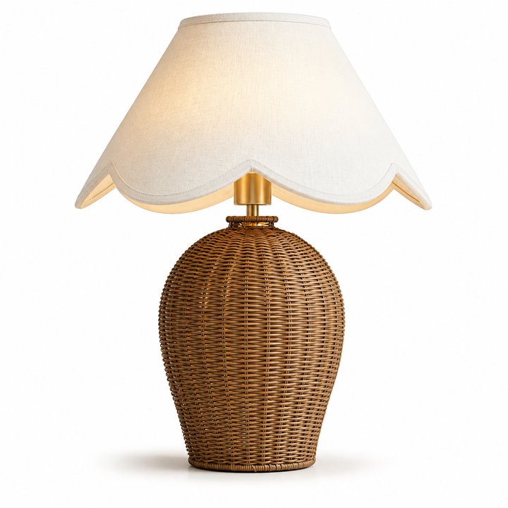 Rattan table lamp with a scalloped white linen shade