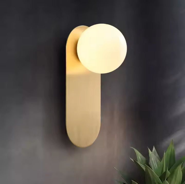 Modern Minimalist Wall Light with Soft Gold Base and Globe Shade