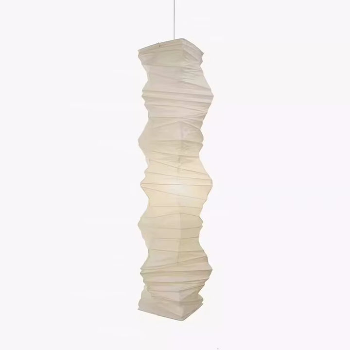 Sculptural ivory twisted pendant light with a layered pleated shade suspended from the ceiling
