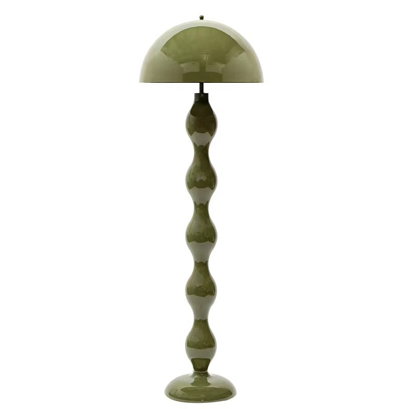 Sculptural olive green floor lamp with a rounded dome shade and curved decorative base