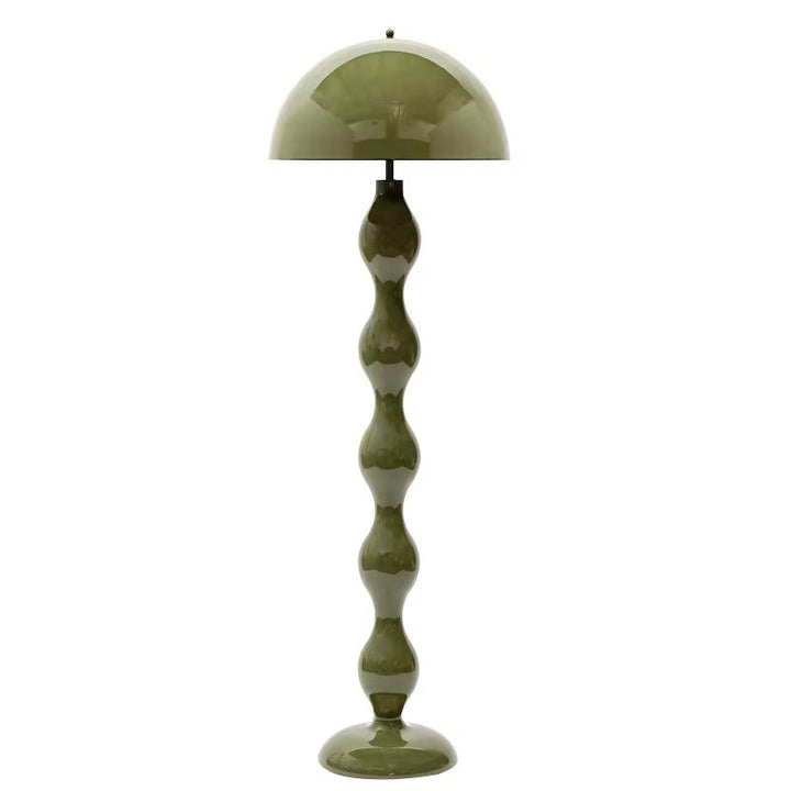 Sculptural olive green floor lamp with a rounded dome shade and curved decorative base