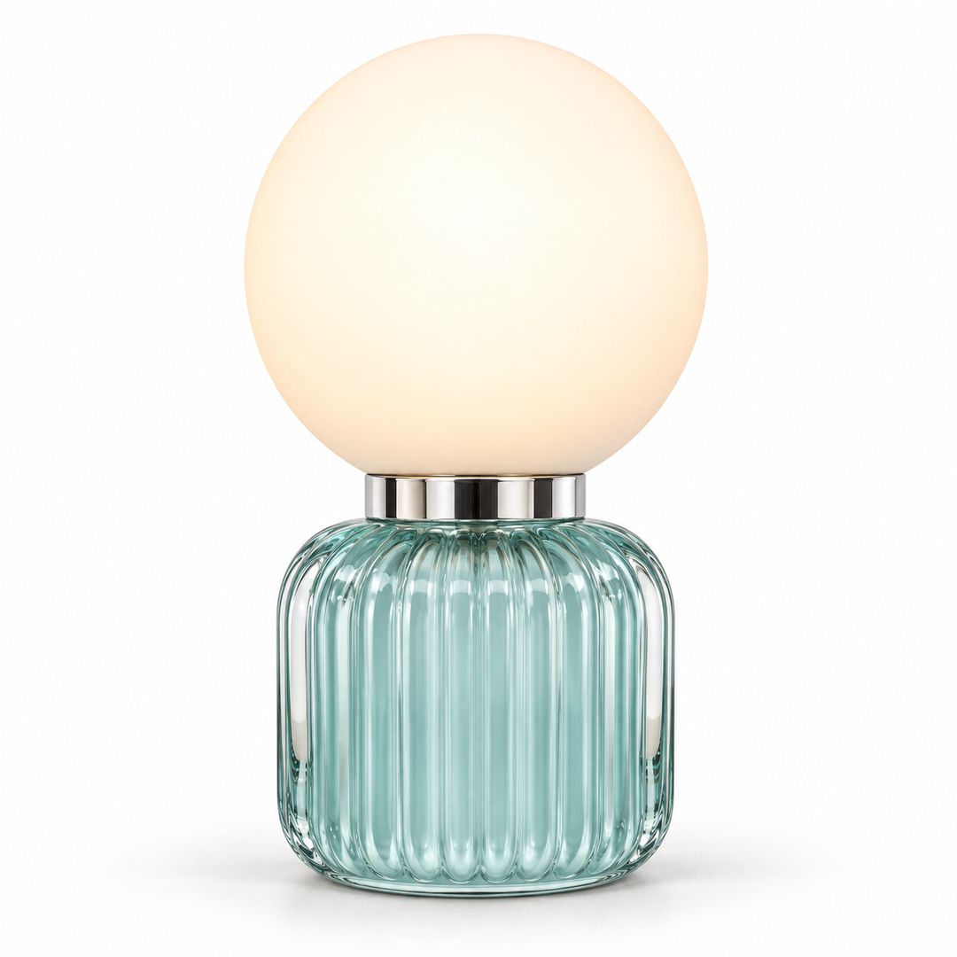 Globe table lamp with a warm white spherical shade, polished metal collar and ribbed aqua glass base.