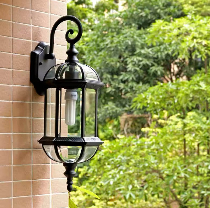 Outdoor Wall LanternOutdoor Wall Lantern with Glass Panels and Vintage DesignThis outdoor wall lantern features a vintage-inspired design with clear glass panels and a durable black metal frame. 
 Perfect for gardens, patios, or entryways, itOutdoor LightsWadi Home