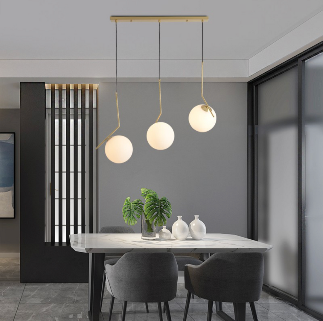 Modern Three-Globe Pendant Light with Brass Finish