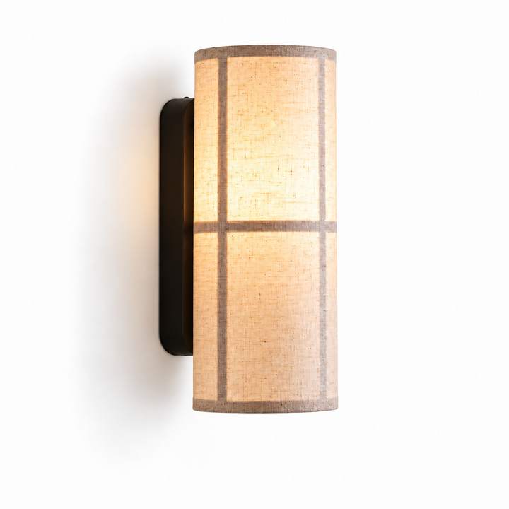 Modern beige fabric wall sconce with a cylindrical linen-style shade