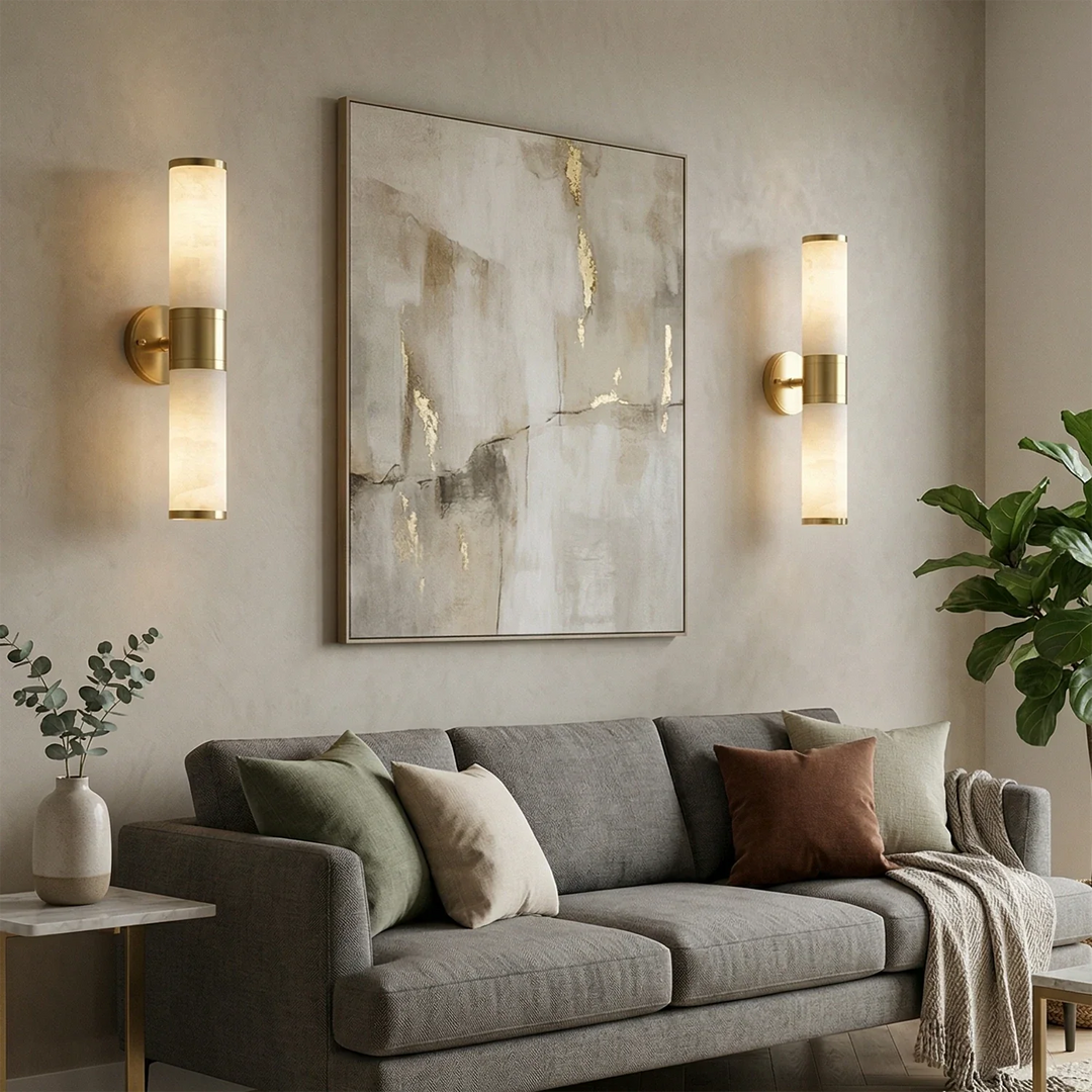 Modern brass wall light with vertical opal glass shades beside artwork in a contemporary living room