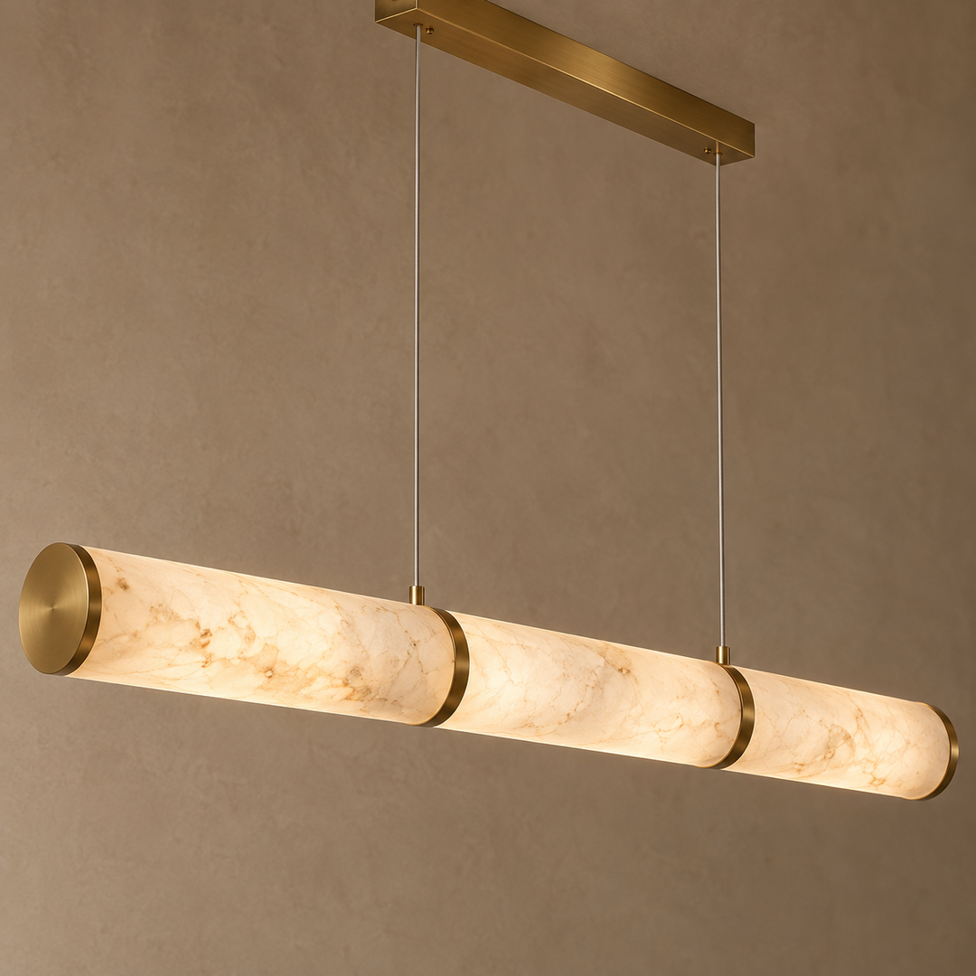 Modern triple marble-effect cylindrical LED pendant light with brass accents and dual cable suspension.