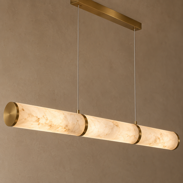 Modern triple marble-effect cylindrical LED pendant light with brass accents and dual cable suspension.