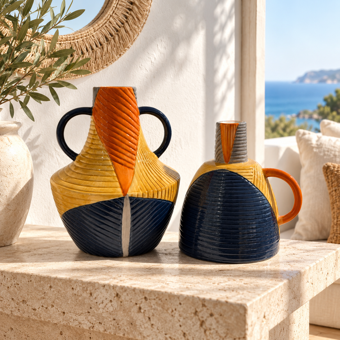 Sculptural ribbed ceramic vase set in navy blue, ochre yellow and terracotta displayed on a stone table