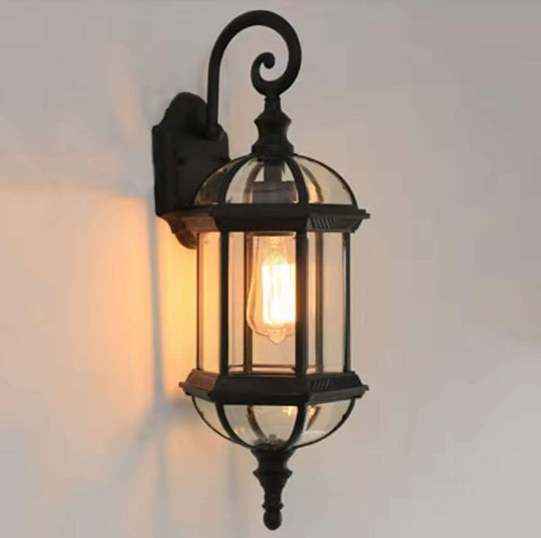 Outdoor Wall LanternOutdoor Wall Lantern with Glass Panels and Vintage DesignThis outdoor wall lantern features a vintage-inspired design with clear glass panels and a durable black metal frame. 
 Perfect for gardens, patios, or entryways, itOutdoor LightsWadi Home