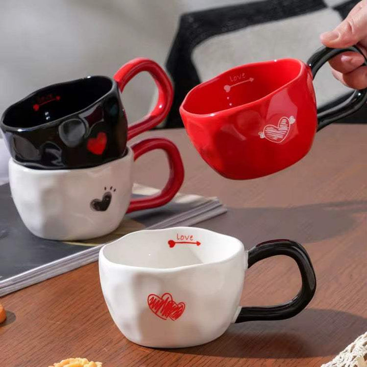 Set of 2 heart design ceramic coffee mugs in red, black, and white with glossy glaze and comfortable handle