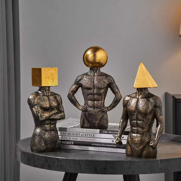 Set of three modern geometric head sculptures with gold muscular figures for contemporary decor