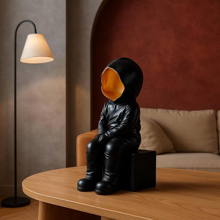 Black Hooded Faceless Sitting Sculpture