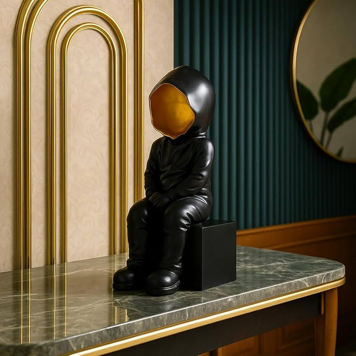 Black Hooded Faceless Sitting Sculpture
