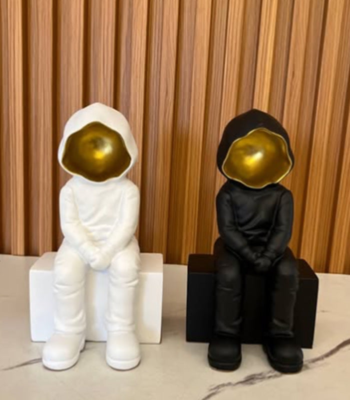 Black Hooded Faceless Sitting Sculpture