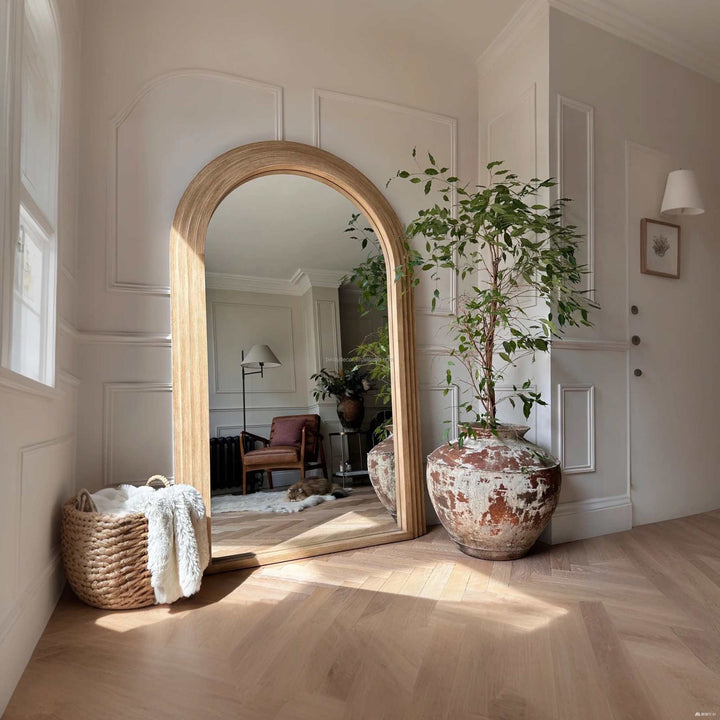 Arched natural wood floor mirror with warm organic frame for bedrooms and living rooms