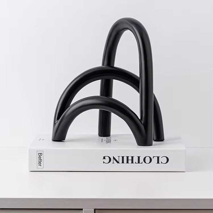 Modern black arch sculpture with smooth curves and minimalist design for contemporary interiors