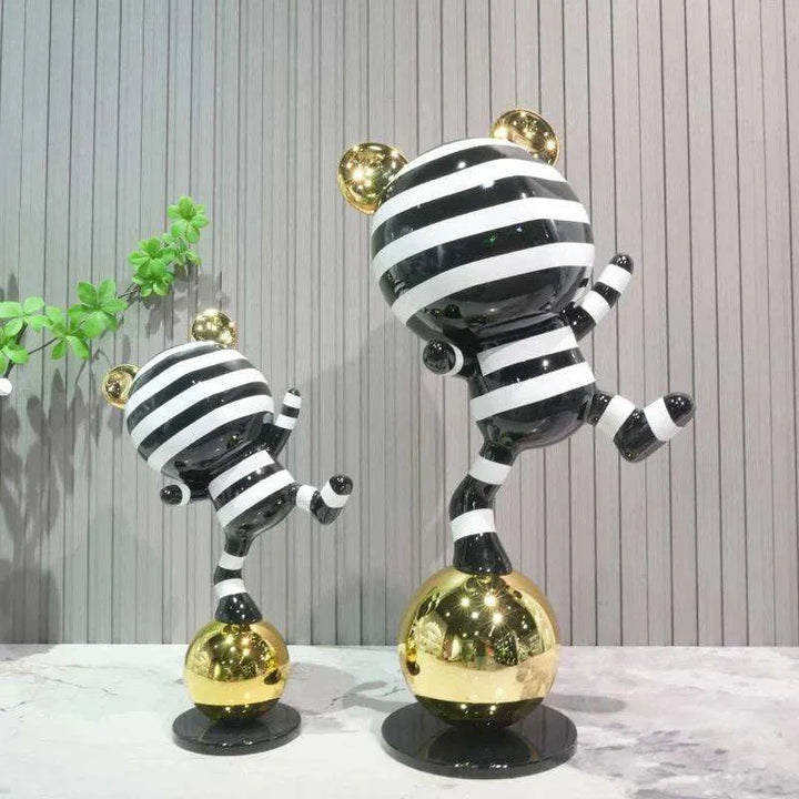 Set of two playful black and white striped bear sculptures with gold accents for modern interiors