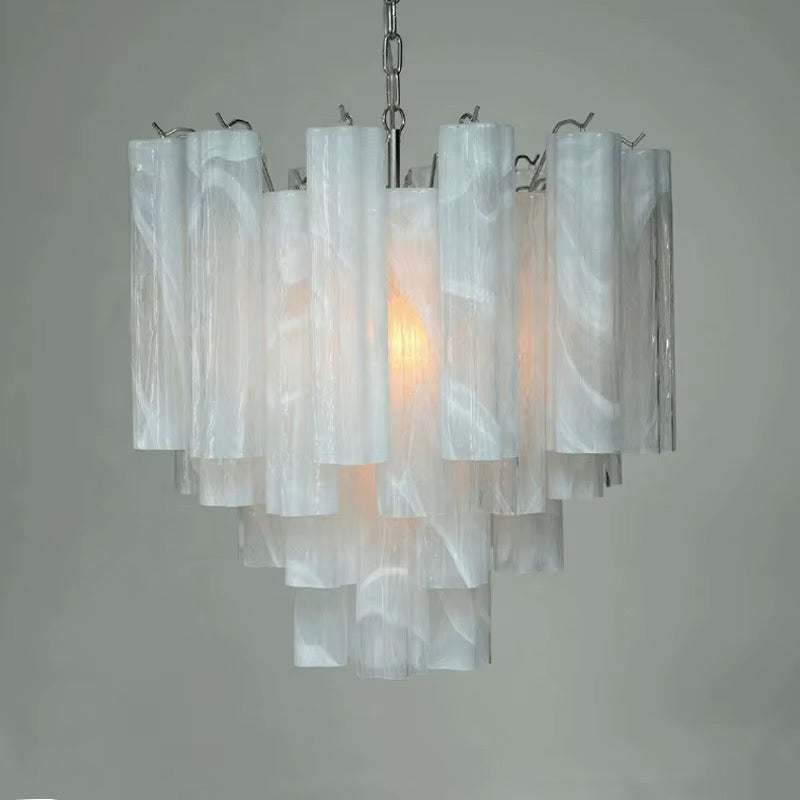 White translucent tube chandelier with layered cylindrical shades and warm glowing light