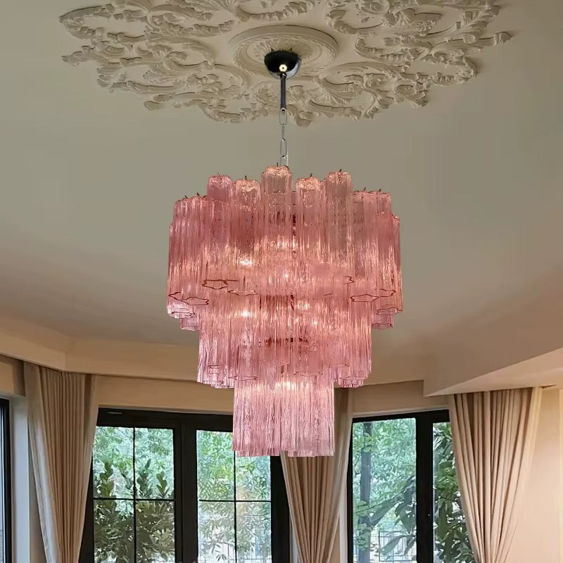 Pink ribbed glass tube chandelier with layered cylindrical shades in an elegant living room