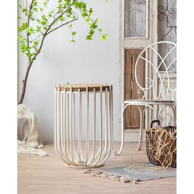 Decorative metal basket on a wooden deck with a chair and plant in the background