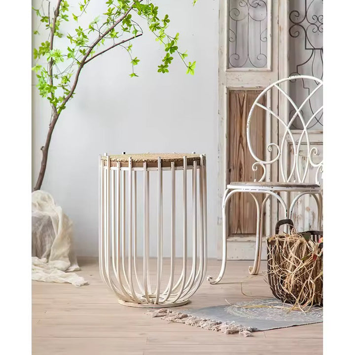 Decorative metal basket on a wooden deck with a chair and plant in the background