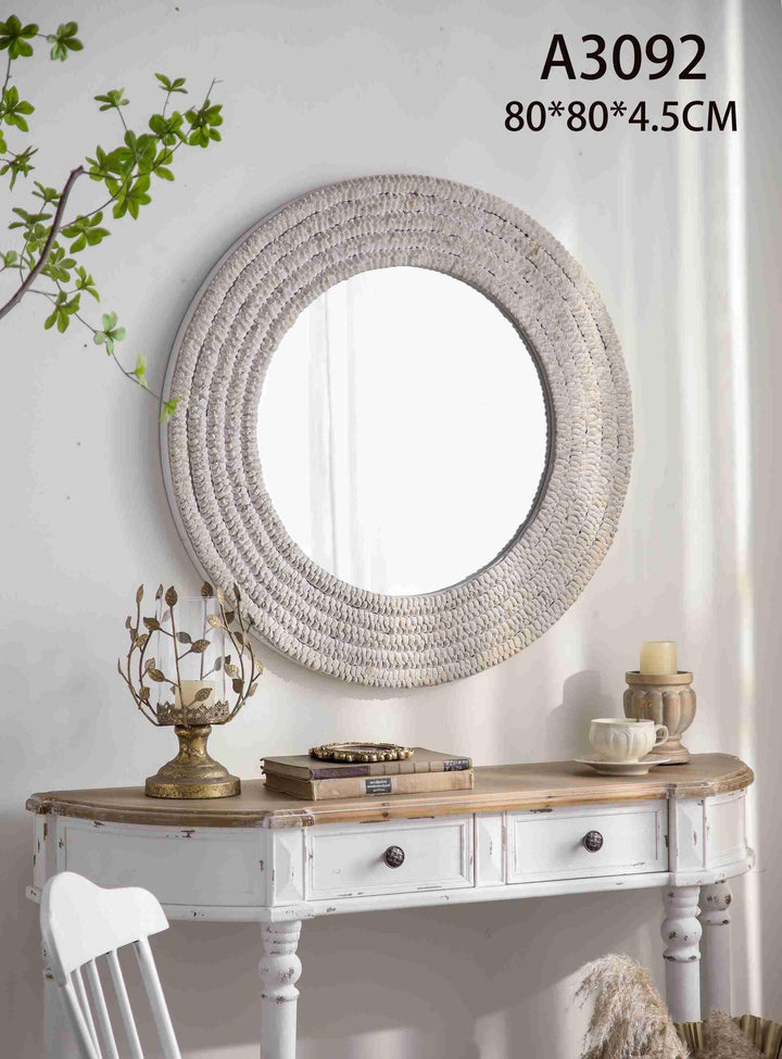 Round textured woven wall mirror with neutral tones and artisanal design