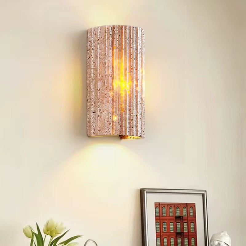 Modern beige textured cylindrical wall sconce with warm light