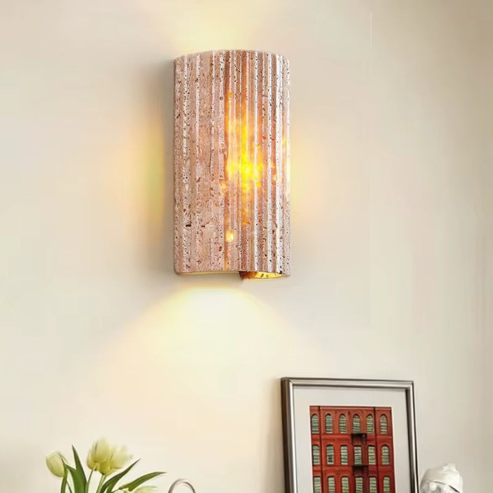 Modern beige textured cylindrical wall sconce with warm light