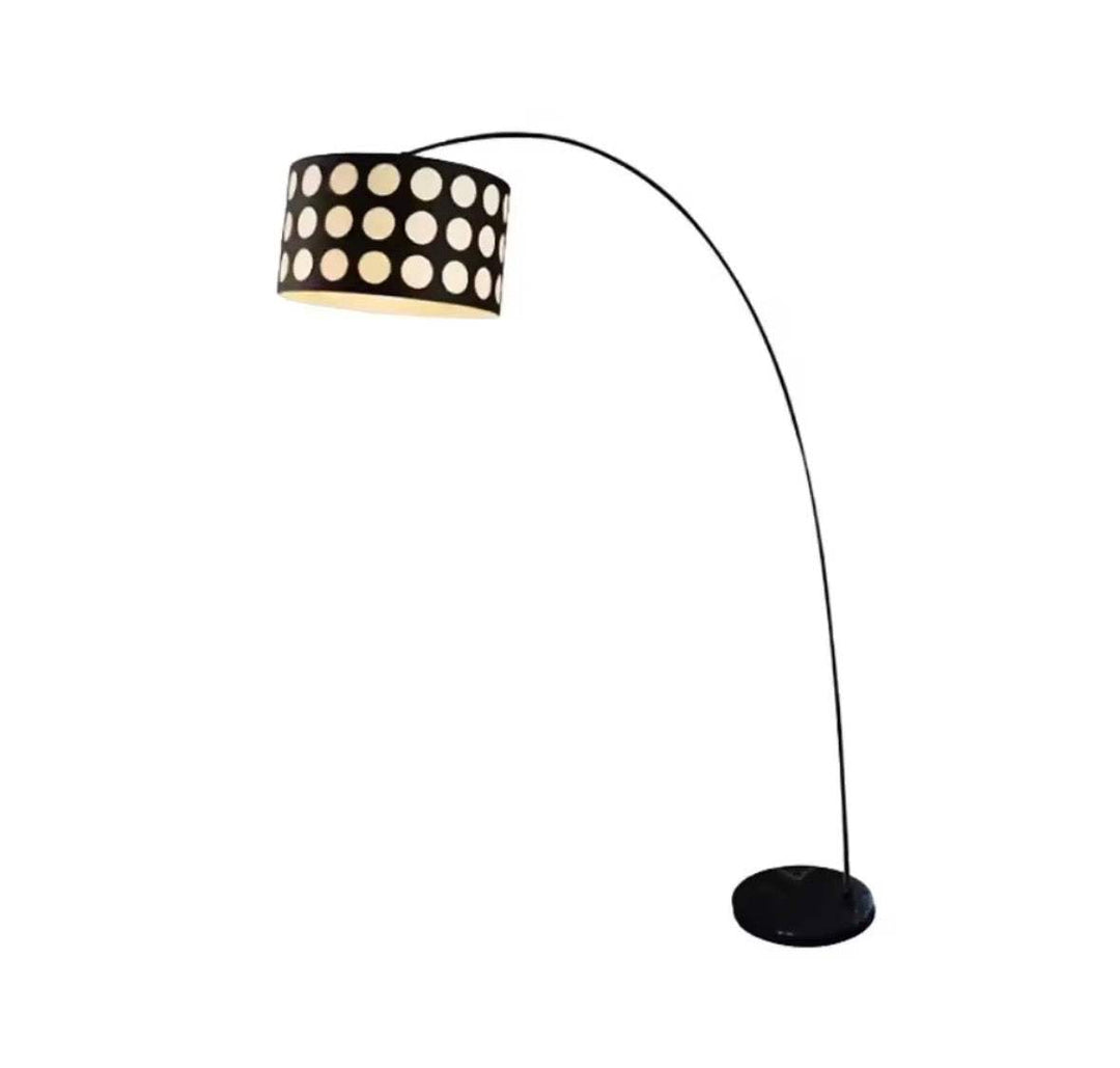Polka dot arc floor lamp with curved black frame and bold fabric shade in modern living room