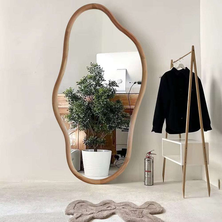 Organic wooden standing mirror with asymmetrical frame for minimalist interiors