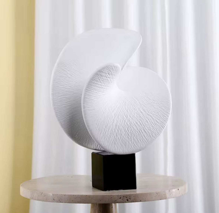 Modern Nautilus Shell Sculpture with smooth curves and textured finish for contemporary decor.
