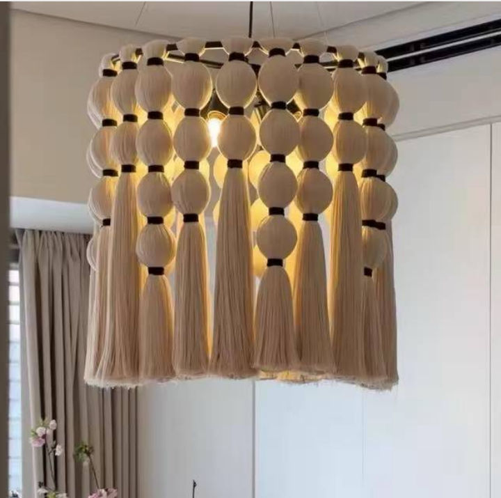 Boho cream yarn beaded tassel chandelier hanging over a modern living area