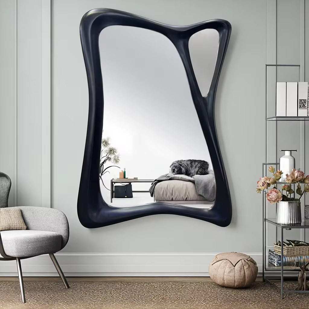 Abstract sculptural wall mirror with unique asymmetrical frame and bold modern design for living rooms or hallways