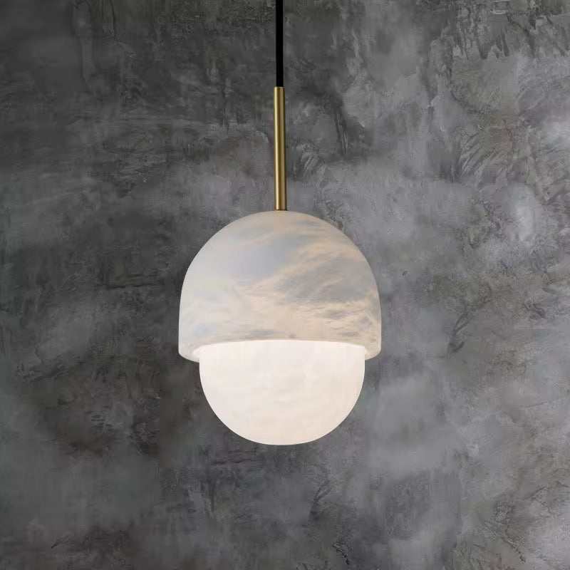 Modern marble dome pendant light with brass stem for contemporary interiors