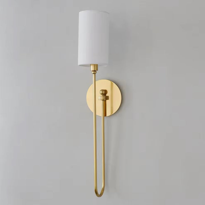 Modern brass wall sconce with white fabric shade and slim vertical gold frame