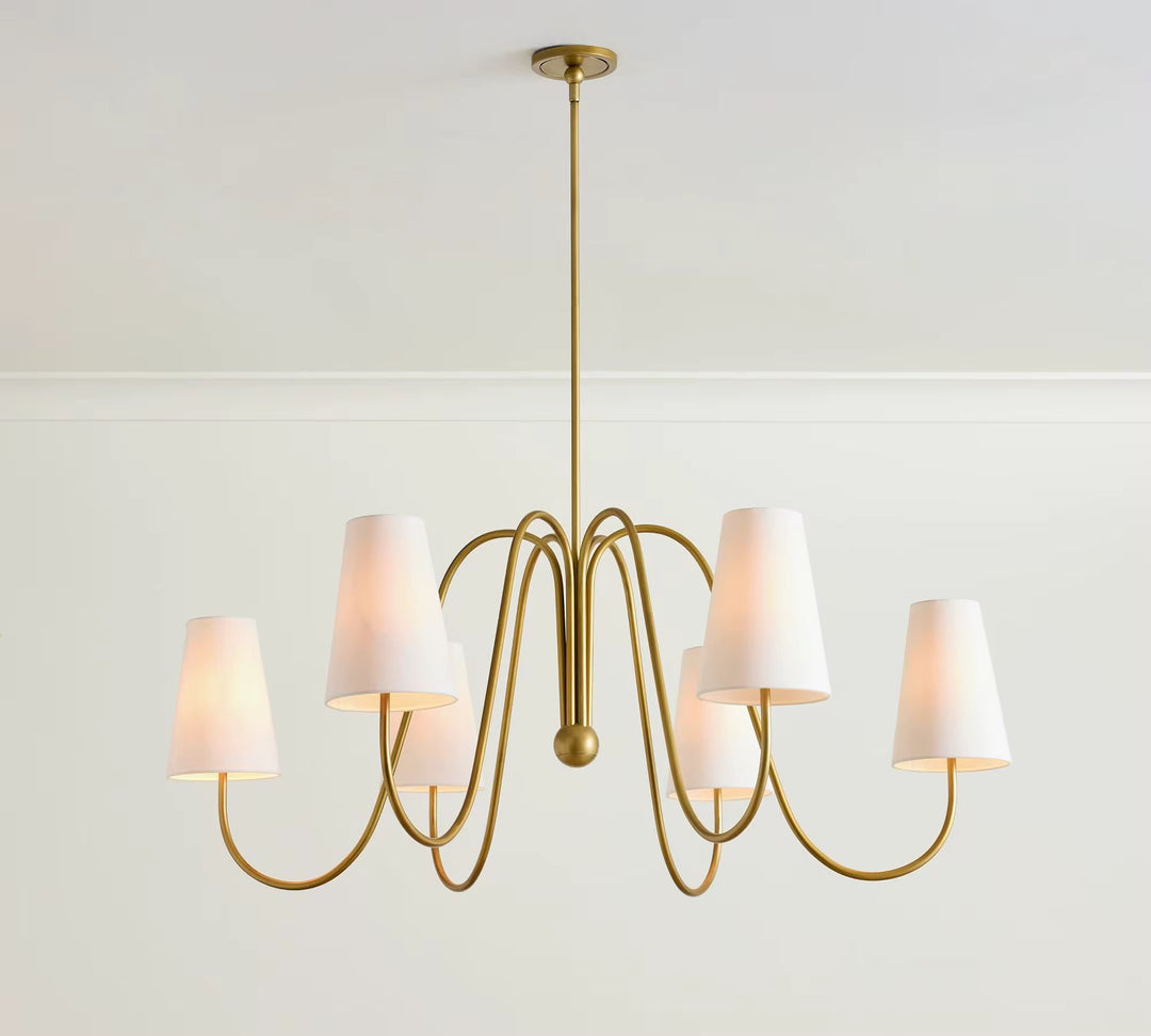Modern six-light gold chandelier with curved ribbon arms and white fabric shades