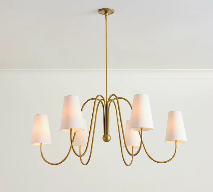 Modern six-light gold chandelier with curved ribbon arms and white fabric shades