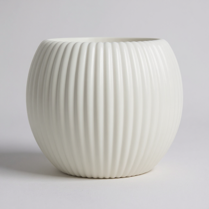 White ceramic pot with ribbed texture on a light gray background