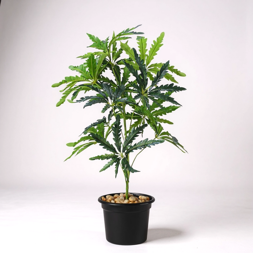 Artificial Philodendron plant in black pot with decorative stones