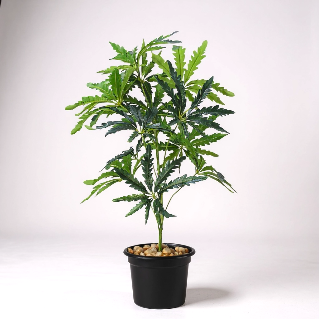 Artificial Philodendron plant in black pot with decorative stones