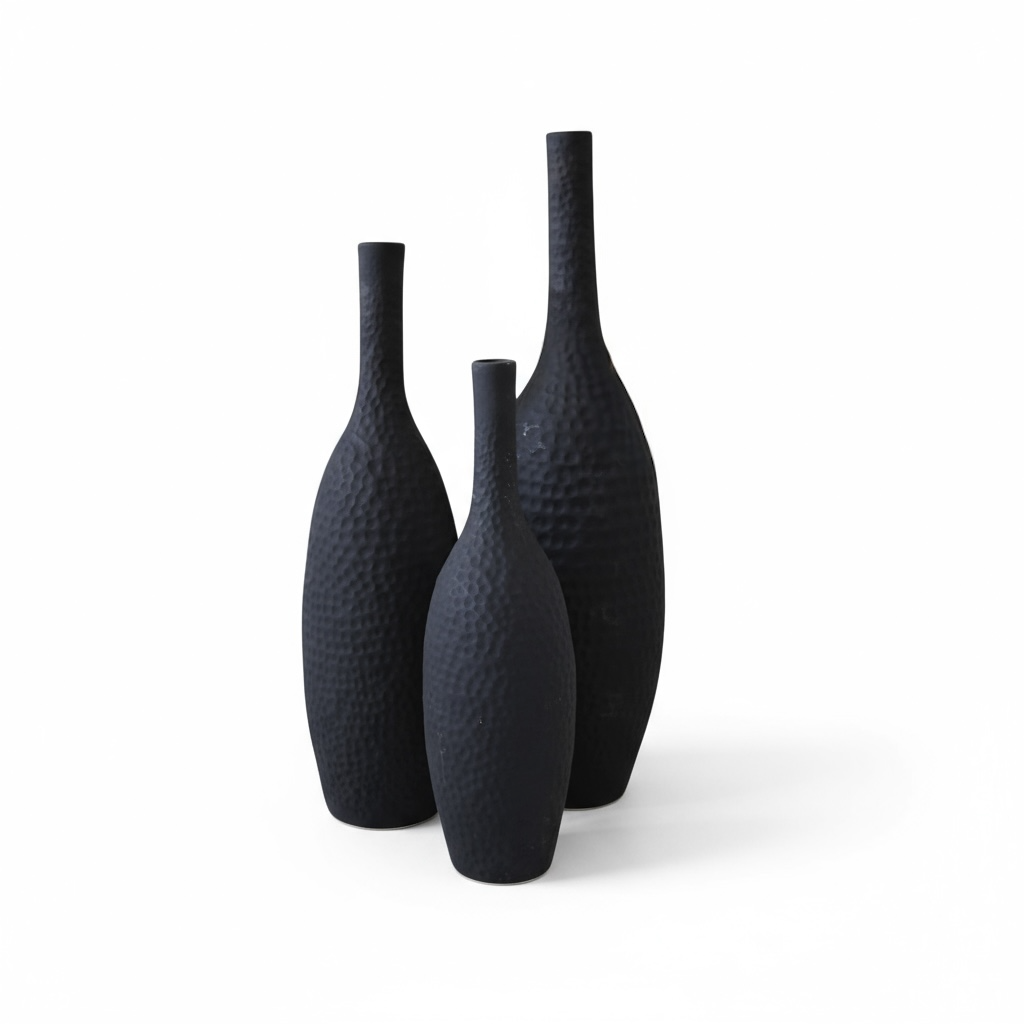 Three black textured vases on a white background